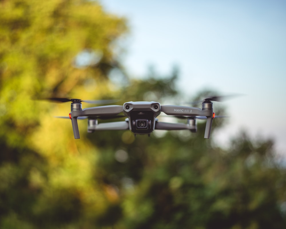 gray drone flying in the sky during daytime