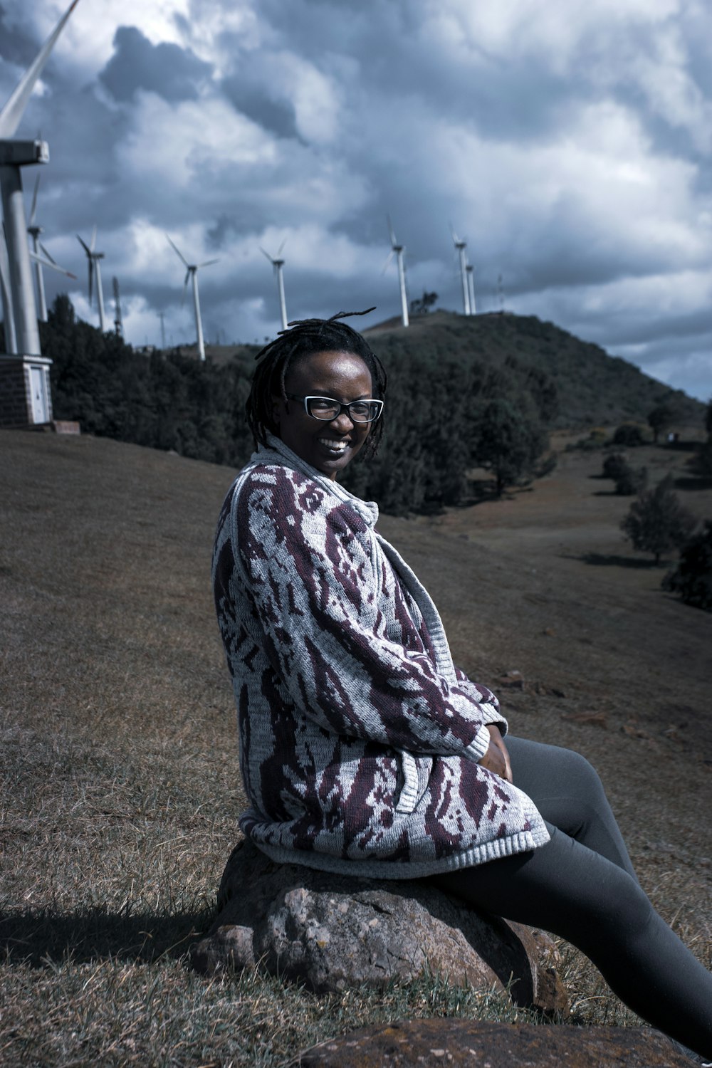 woman in black framed eyeglasses sitting on brown chair