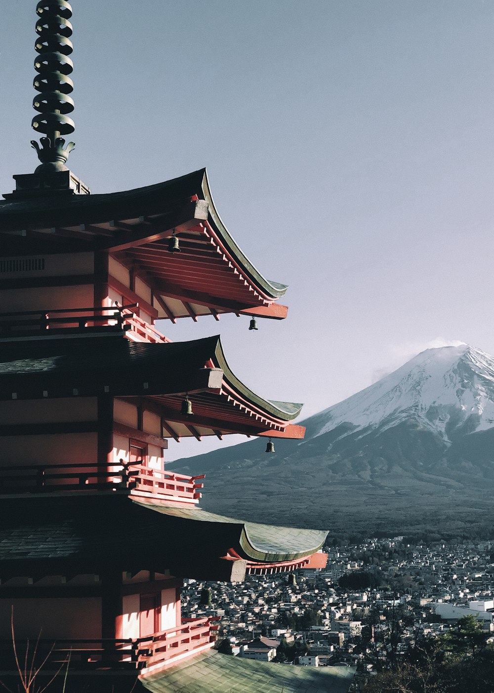 a tall pagoda with a mountain in the background