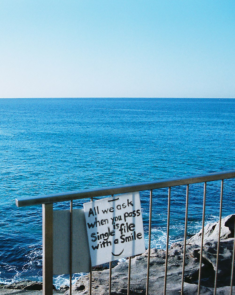 white and black wooden signage on blue sea during daytime