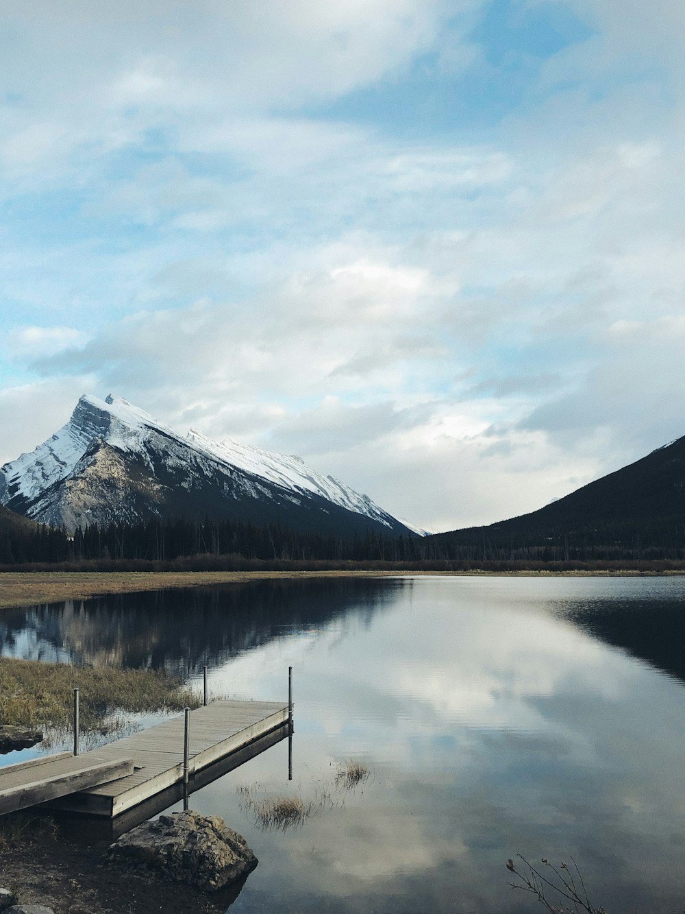 a wooden dock sitting in the middle of a lake