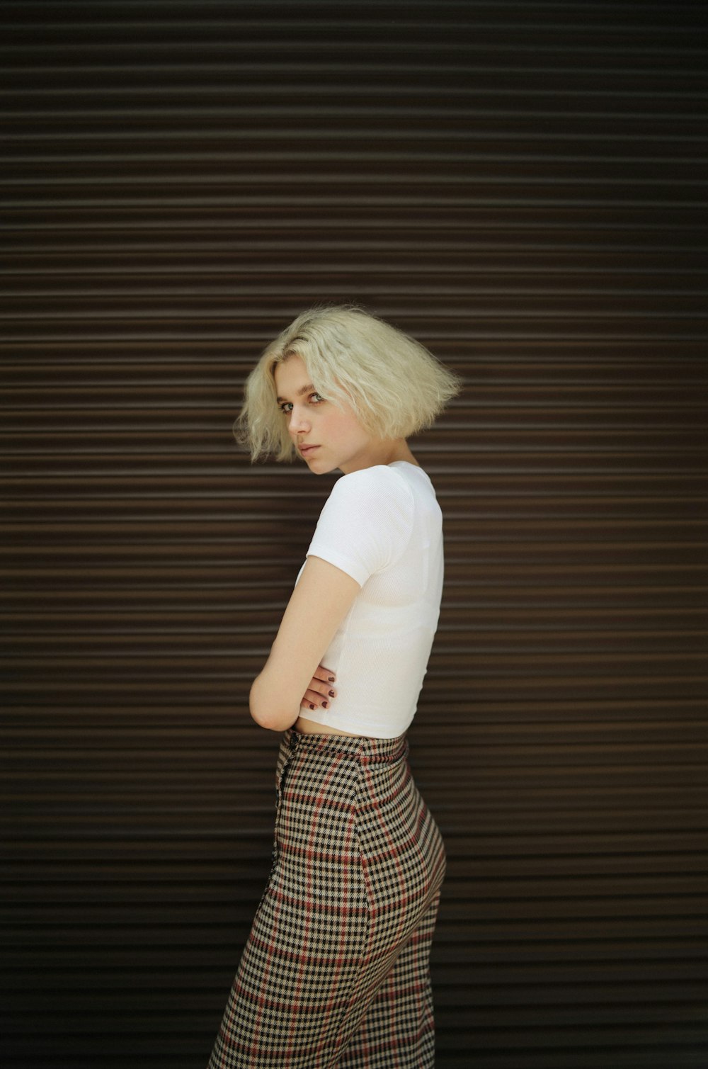 woman in white t-shirt and black and white striped skirt