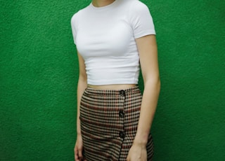 woman in white crew neck t-shirt and black and white plaid skirt