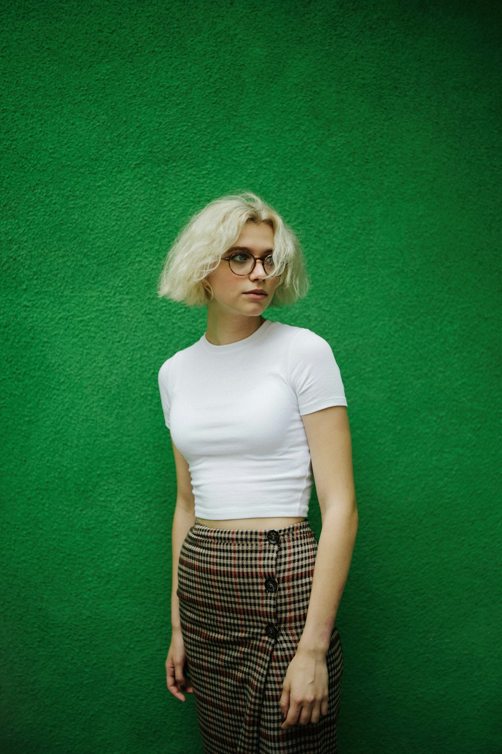 woman in white crew neck t-shirt and black and white plaid skirt