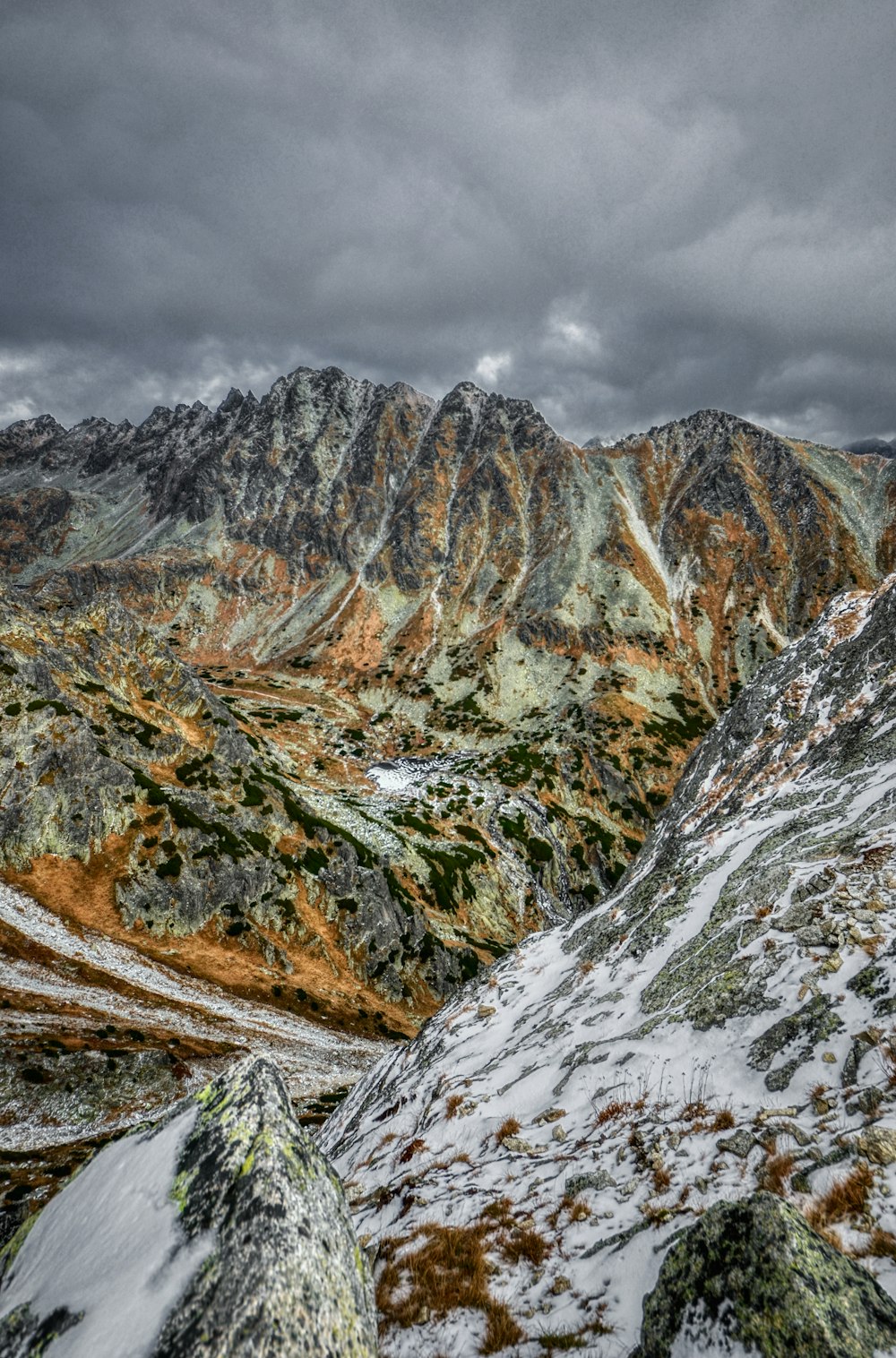 brown and gray rocky mountain under white cloudy sky during daytime