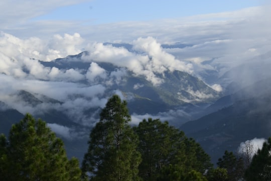 green trees on mountain under white clouds during daytime in Ramechhap Nepal