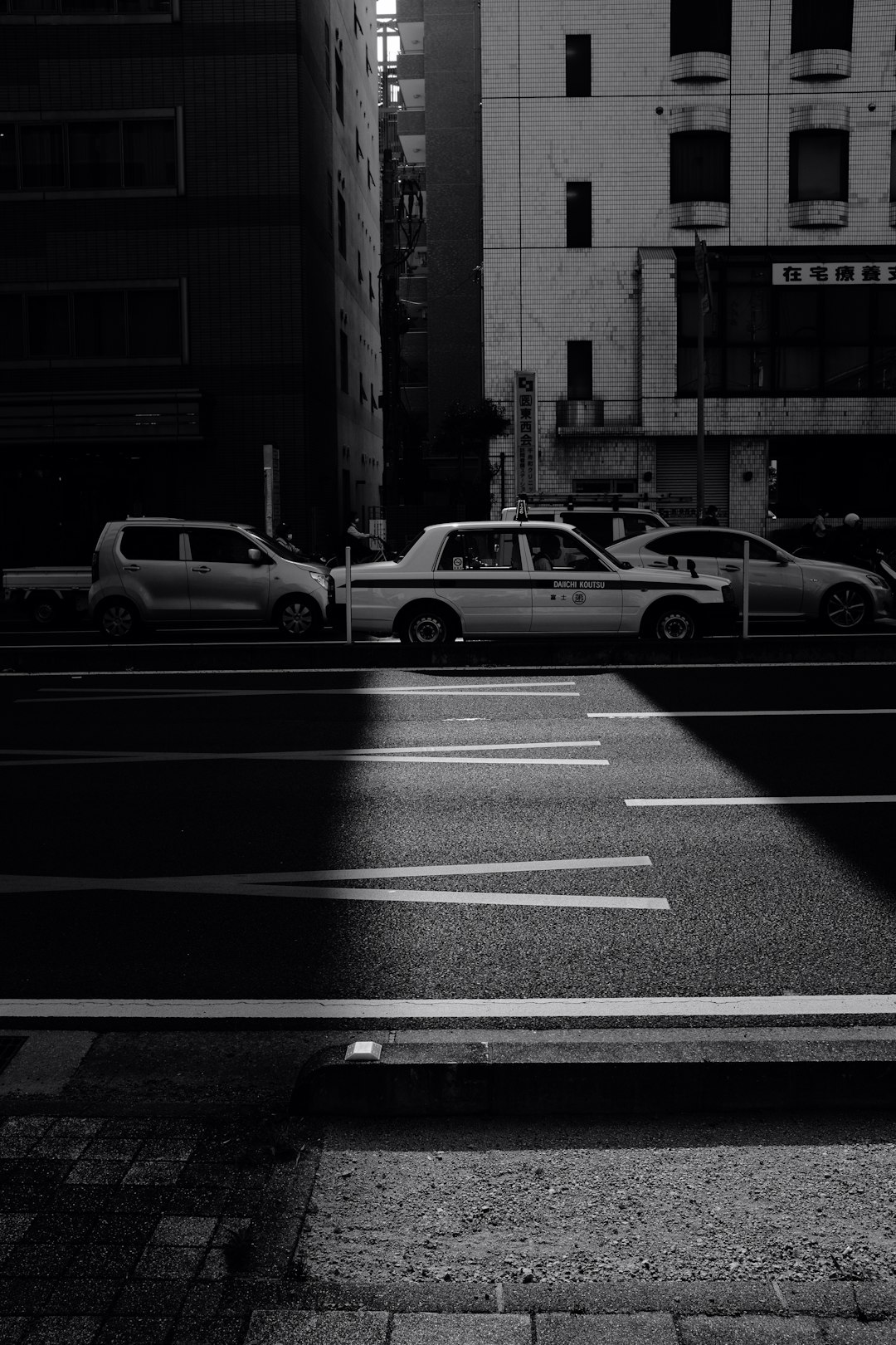 grayscale photo of cars on road