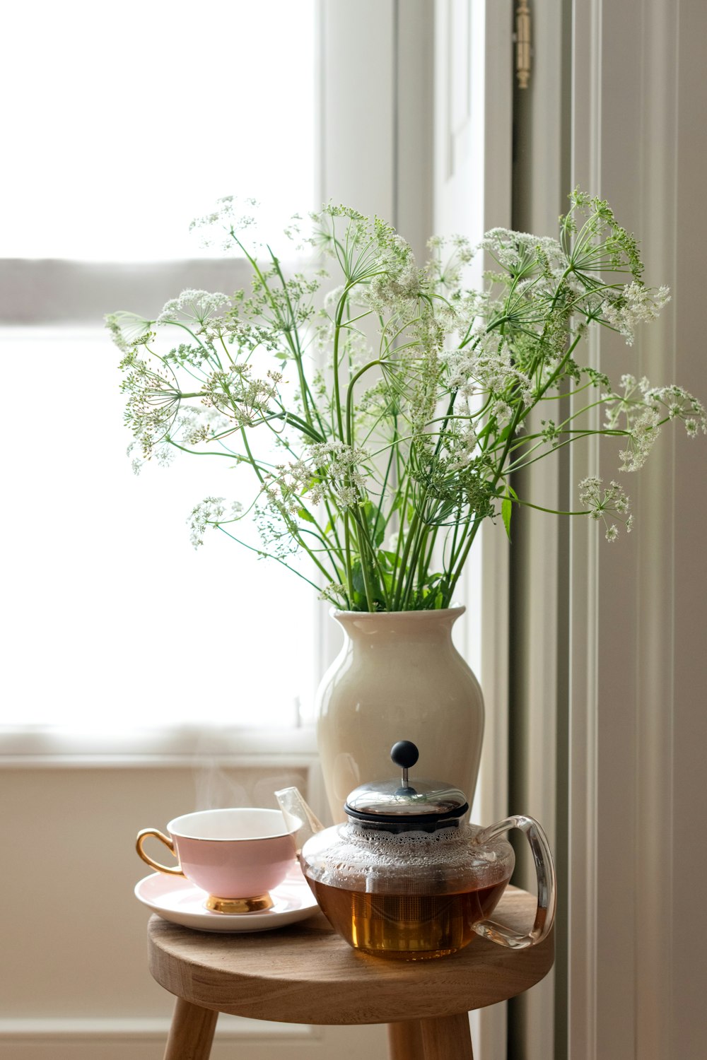 white ceramic teacup on saucer beside white flowers