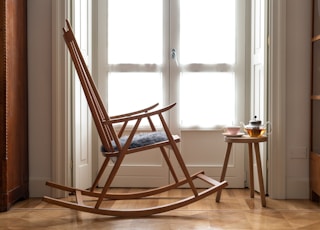 brown wooden chair near window