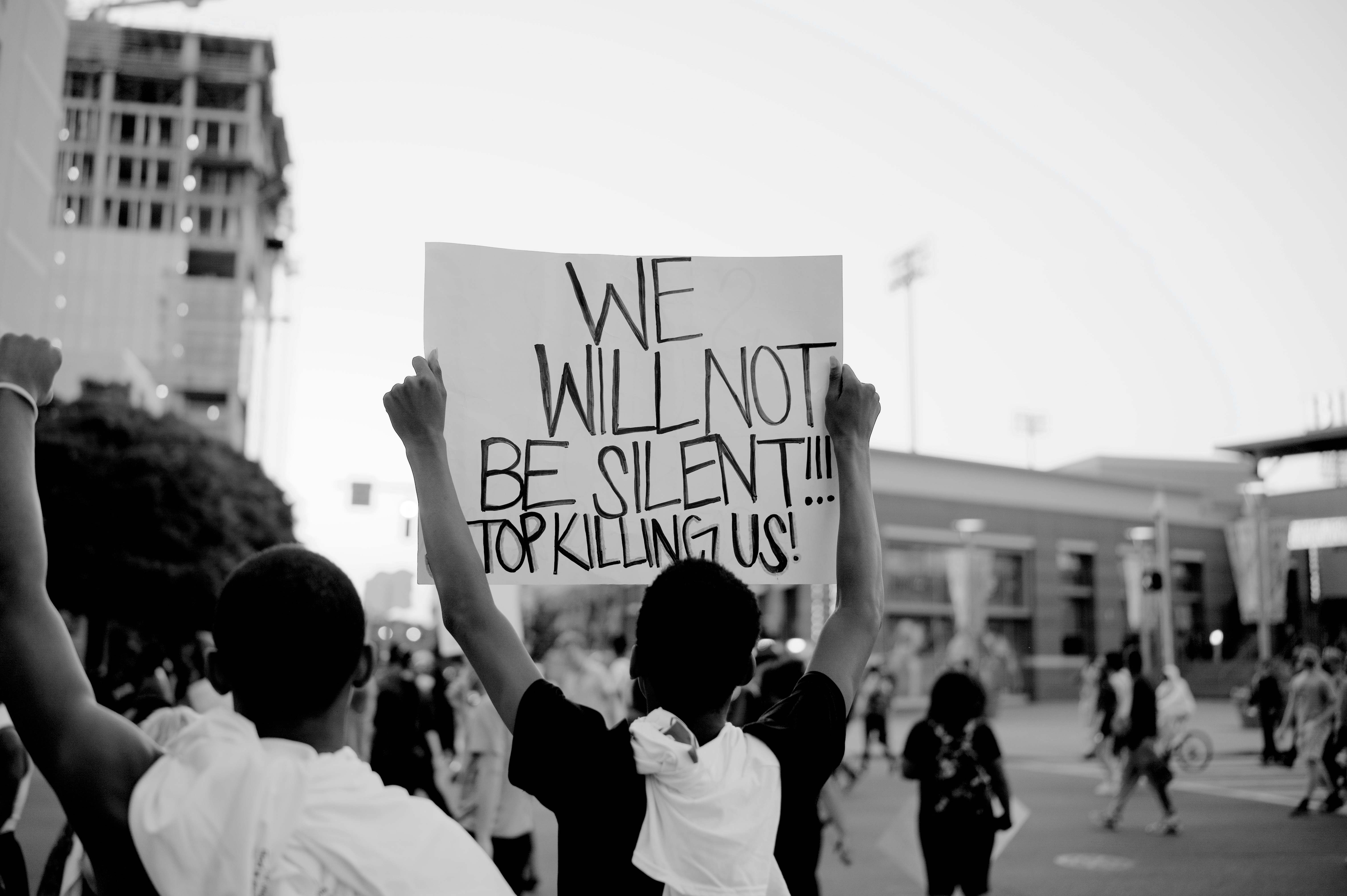 grayscale photo of people holding white printer paper