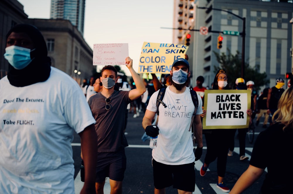 woman in white crew neck t-shirt and black shorts holding white and blue banner