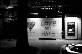 a black and white photo of a love not hate sign