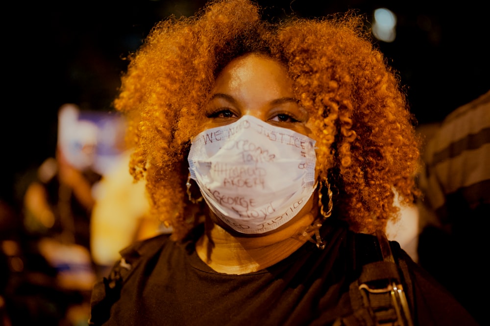 woman in brown crew neck shirt with white face mask