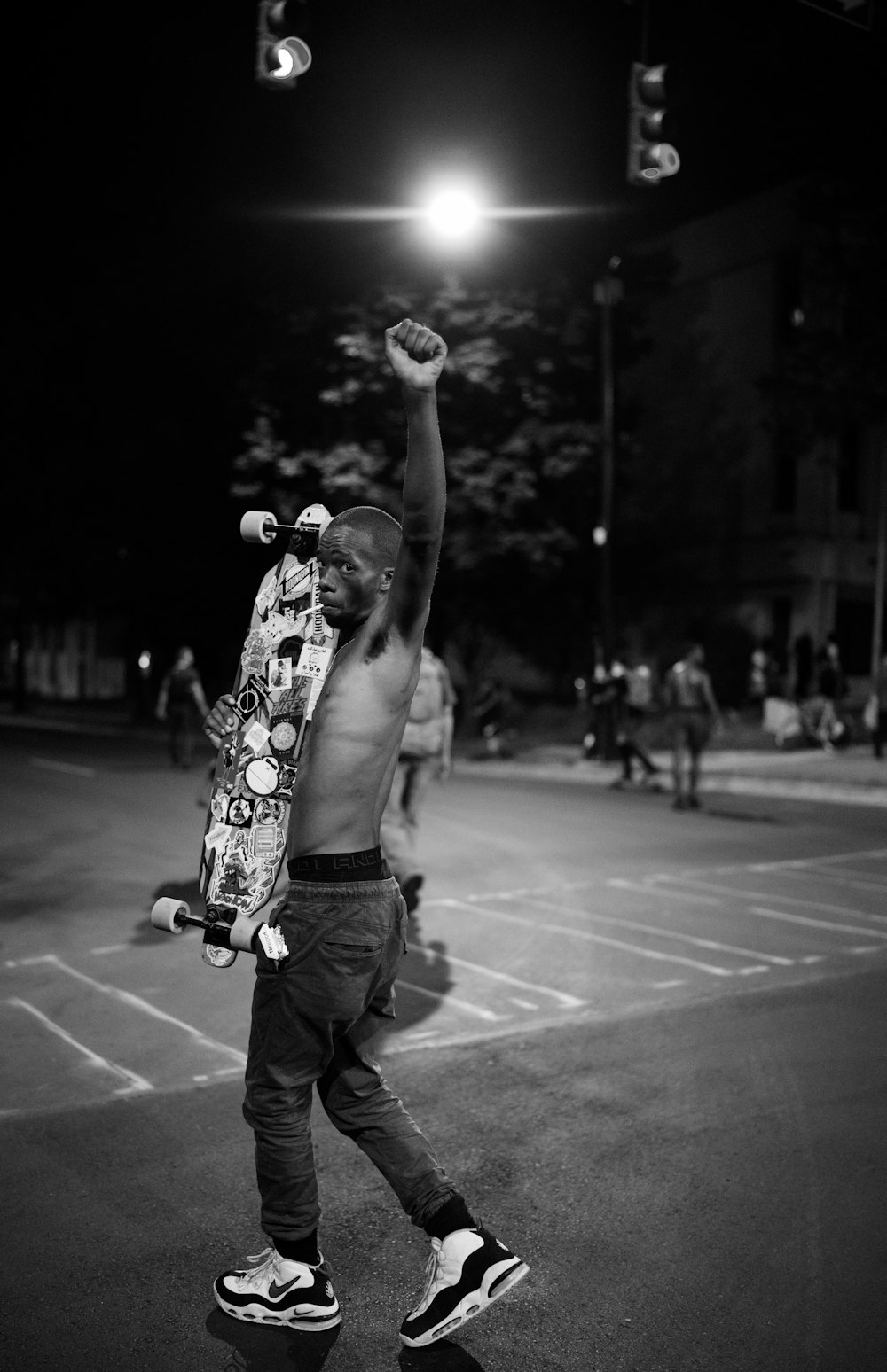 man in black pants holding ball in grayscale photography