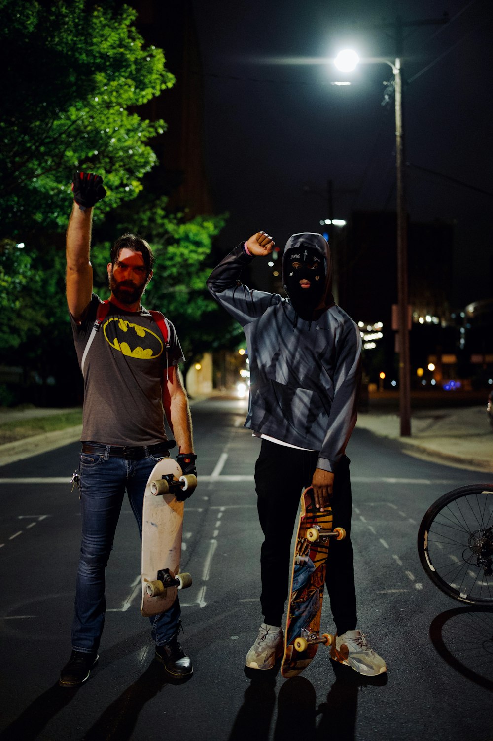 man in gray crew neck t-shirt and black mask holding skateboard