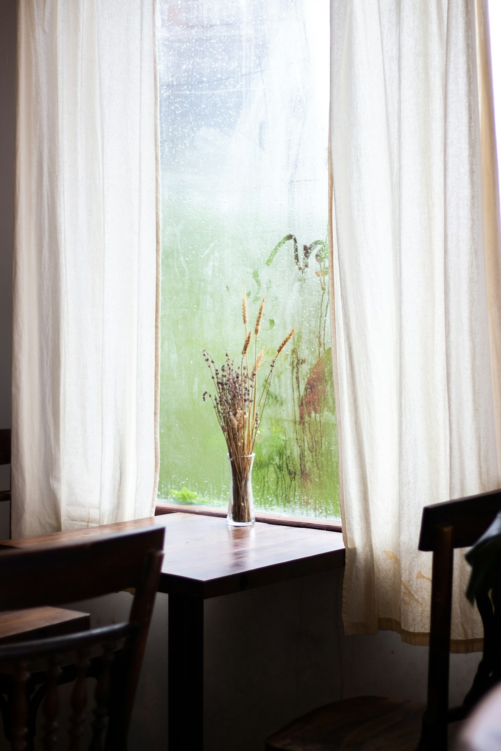 white window curtain near brown wooden table