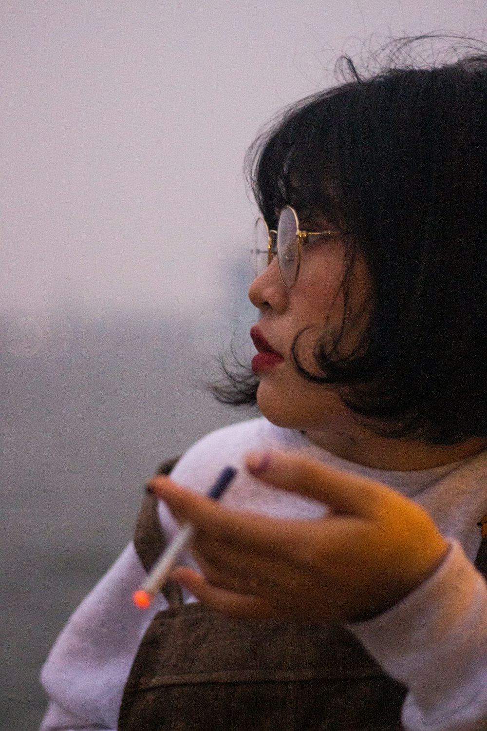 woman in white shirt holding white smartphone