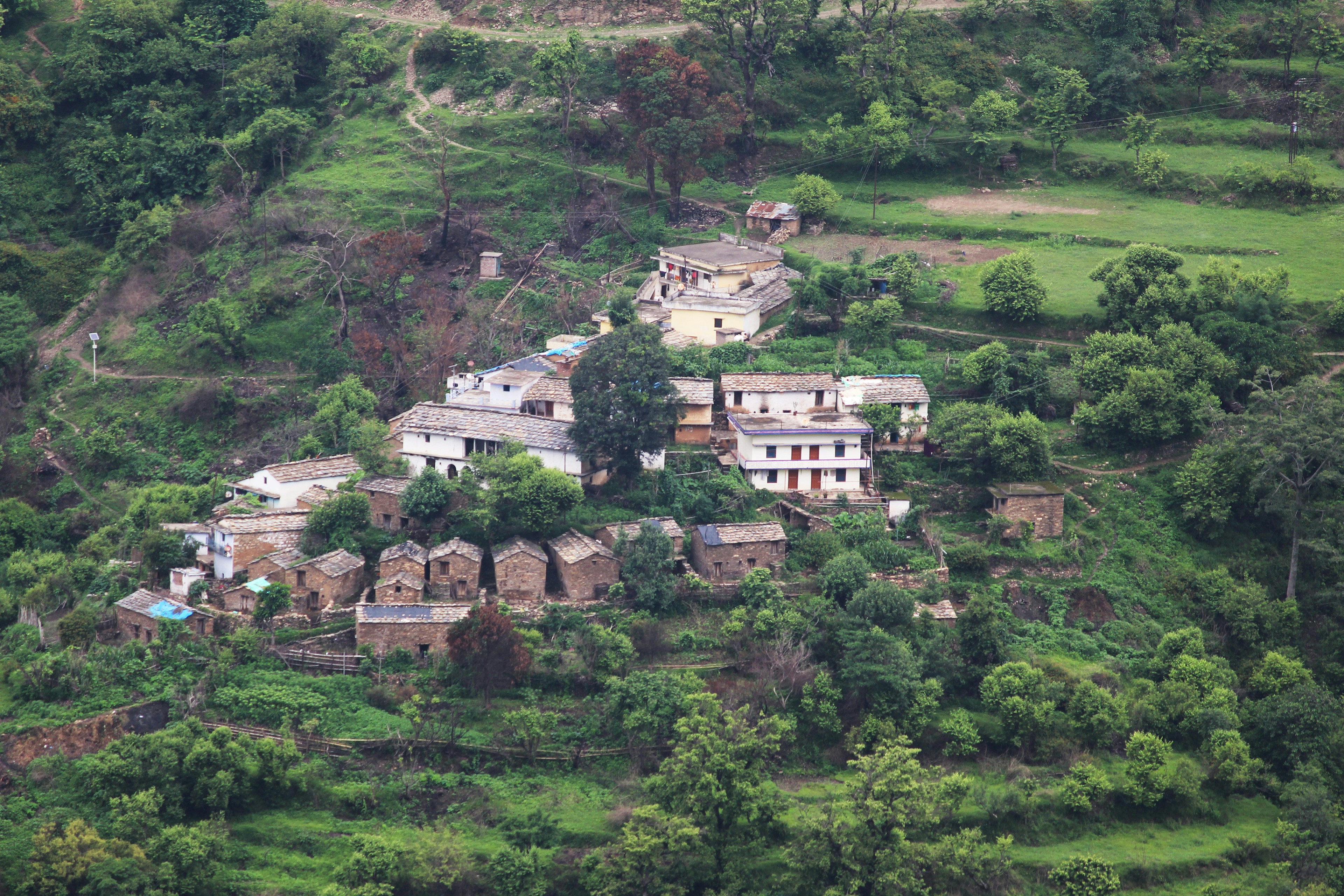 white and brown concrete houses on green grass field