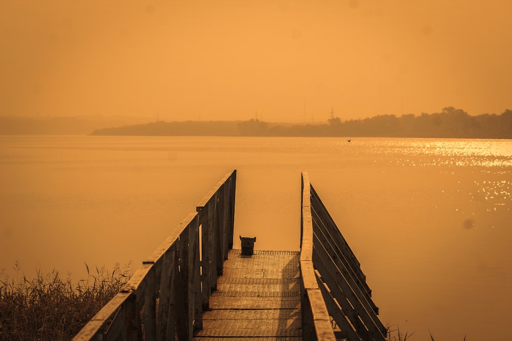 brown wooden dock on body of water during daytime