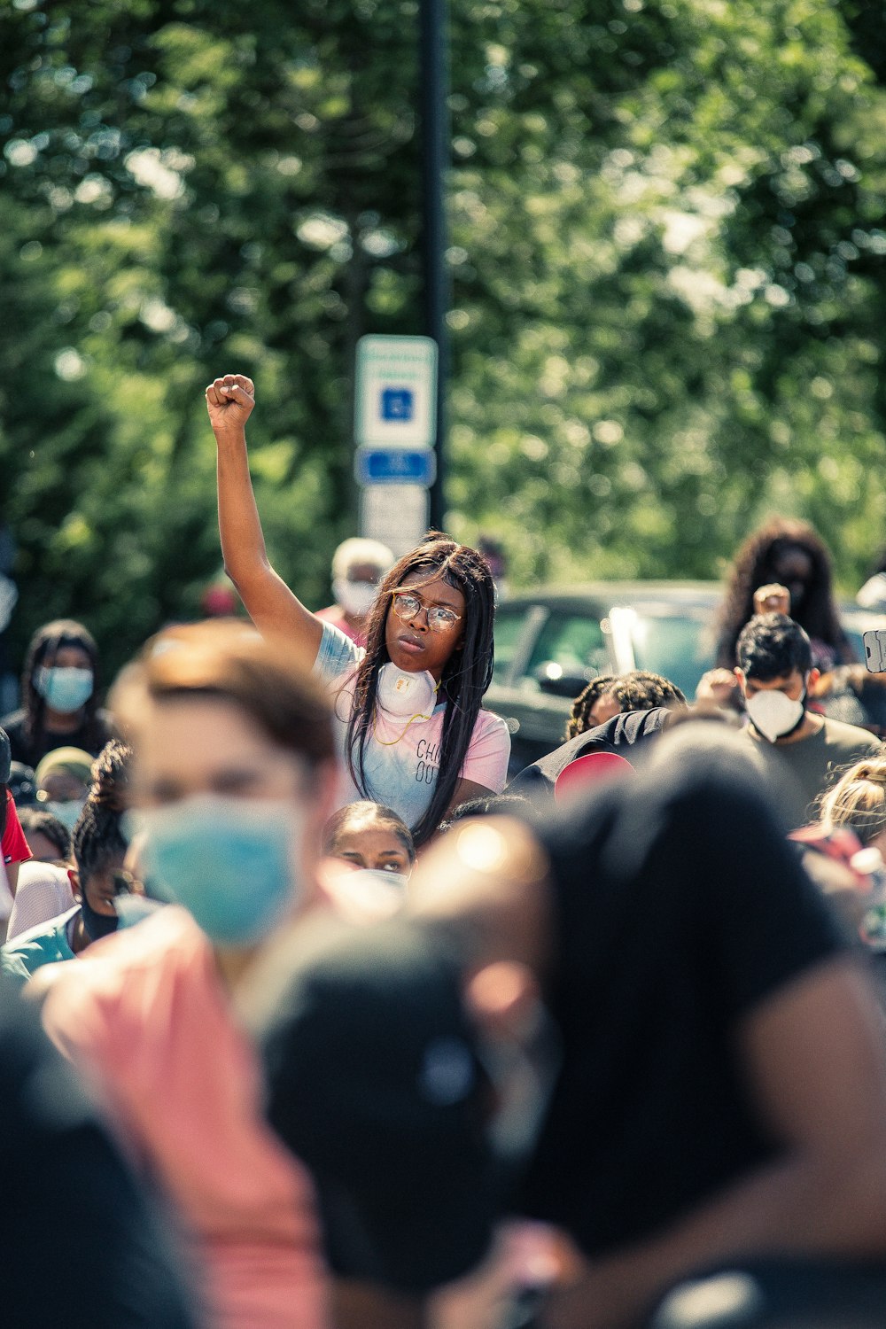 woman in black t-shirt raising her right hand