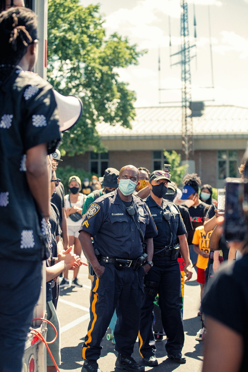 people in black uniform standing on road during daytime