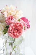 pink and white roses in white vase
