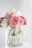 pink roses in clear glass vase