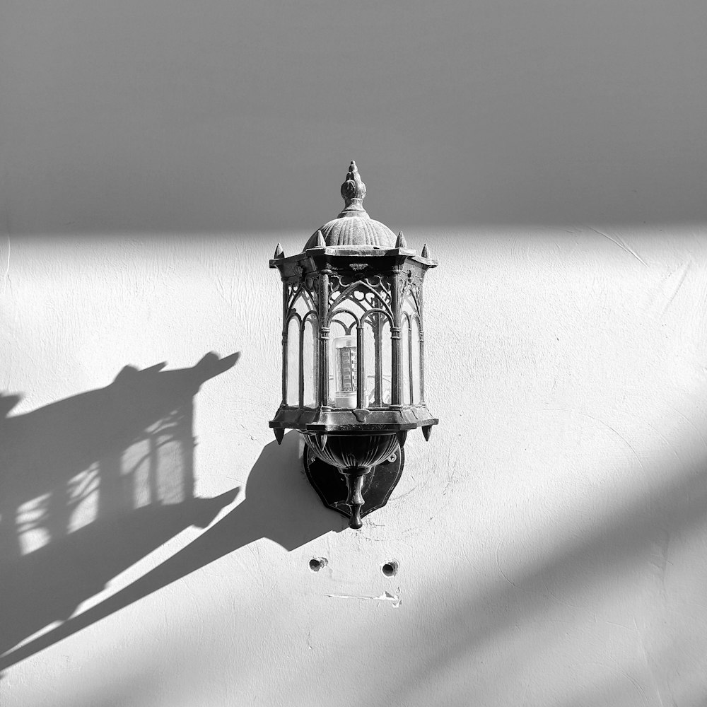 black lantern lamp on white wall