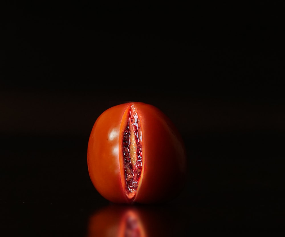 red tomato on black surface