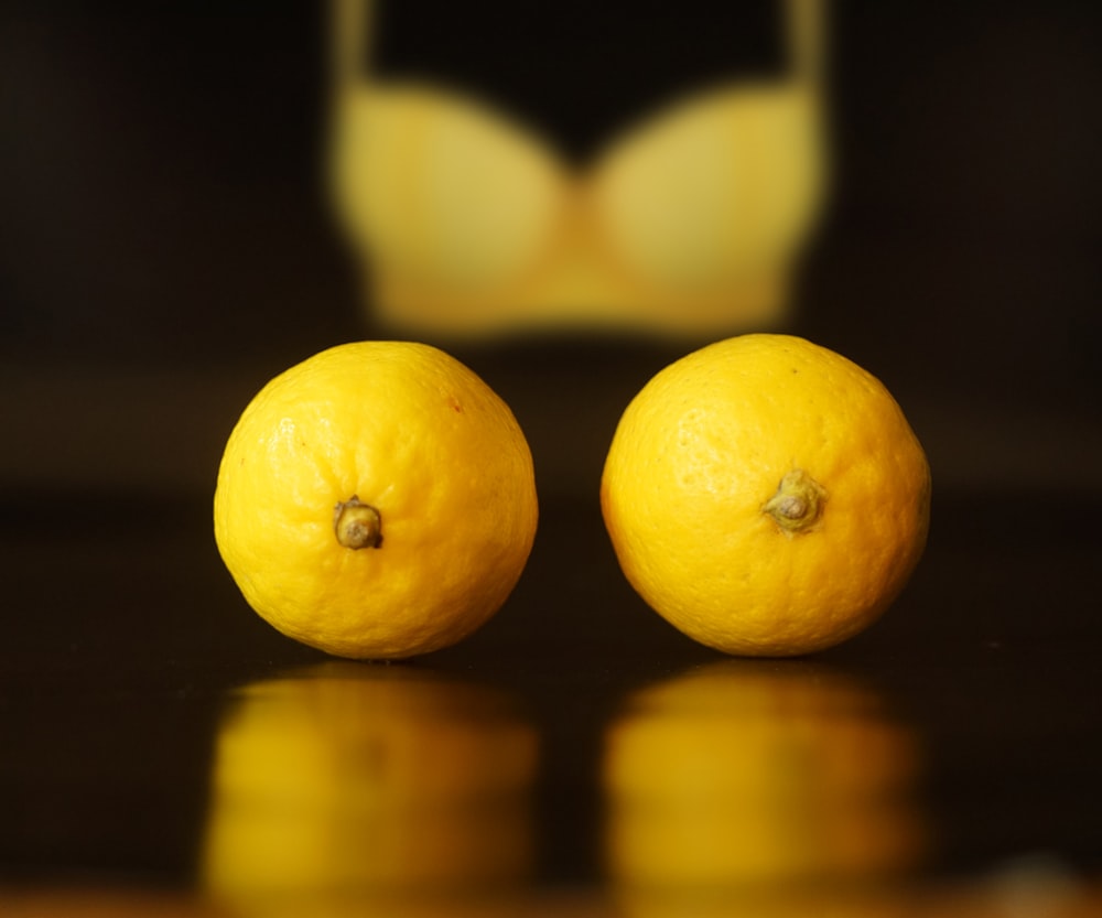 yellow lemon fruit on brown wooden table