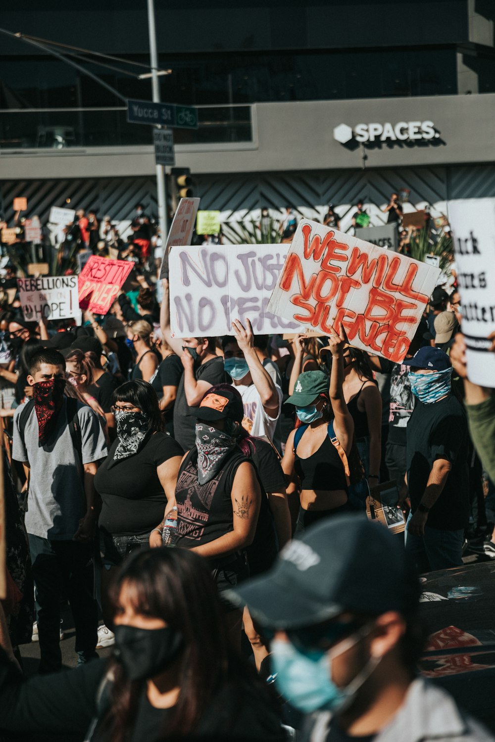 people holding green and white banner during daytime