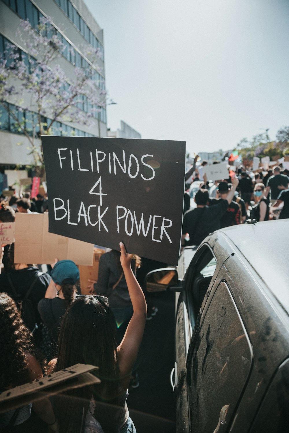 people holding black and white happy birthday signage during daytime