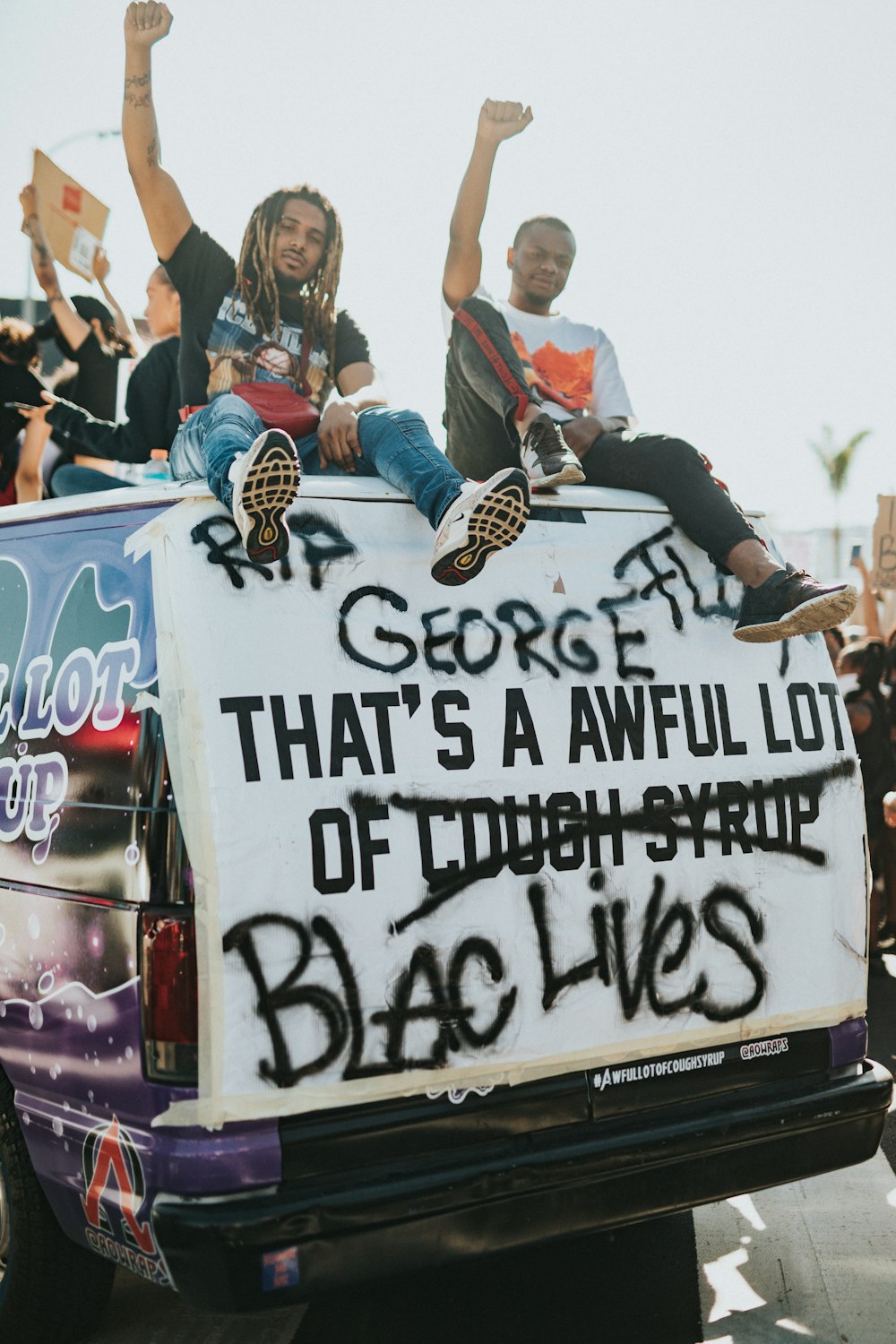 people on a white and blue ice cream truck during daytime