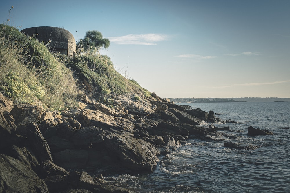 brown rock formation near body of water during daytime