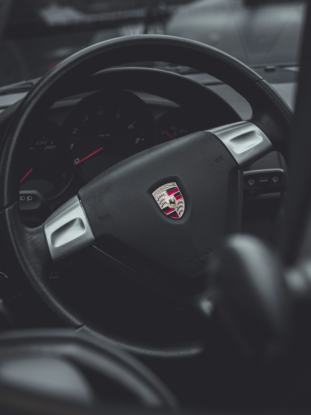 black porsche car steering wheel