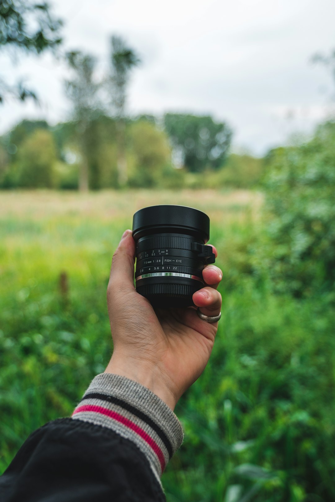 person holding black camera lens