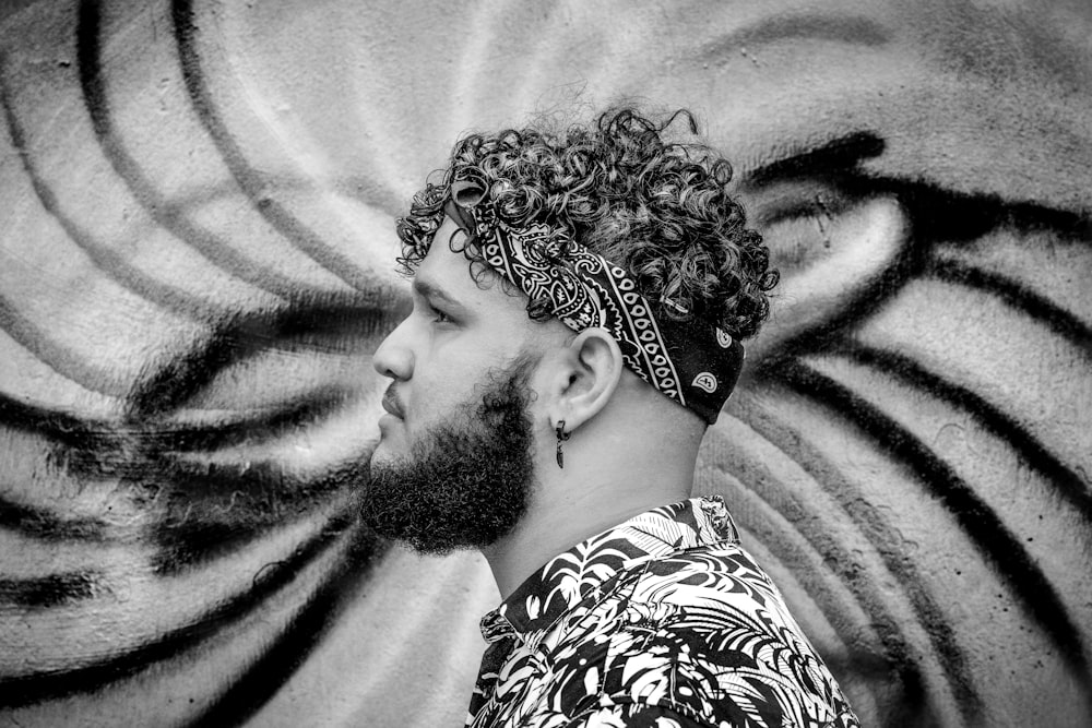 grayscale photo of man in floral shirt