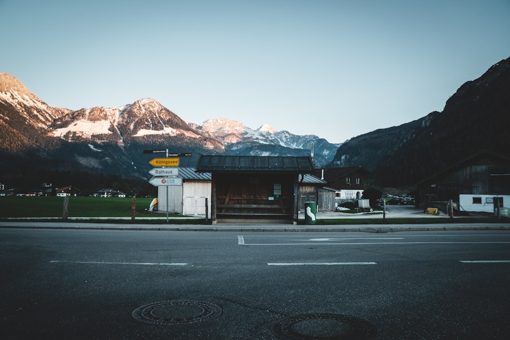 white and brown concrete building near mountain under blue sky during daytime