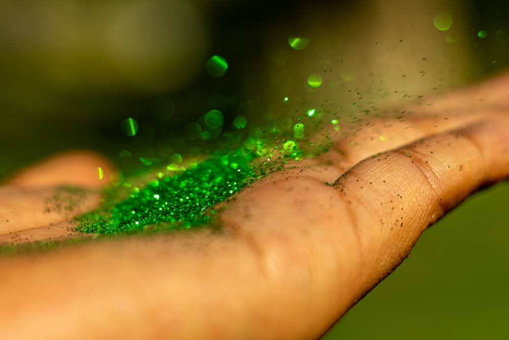 water droplets on persons finger