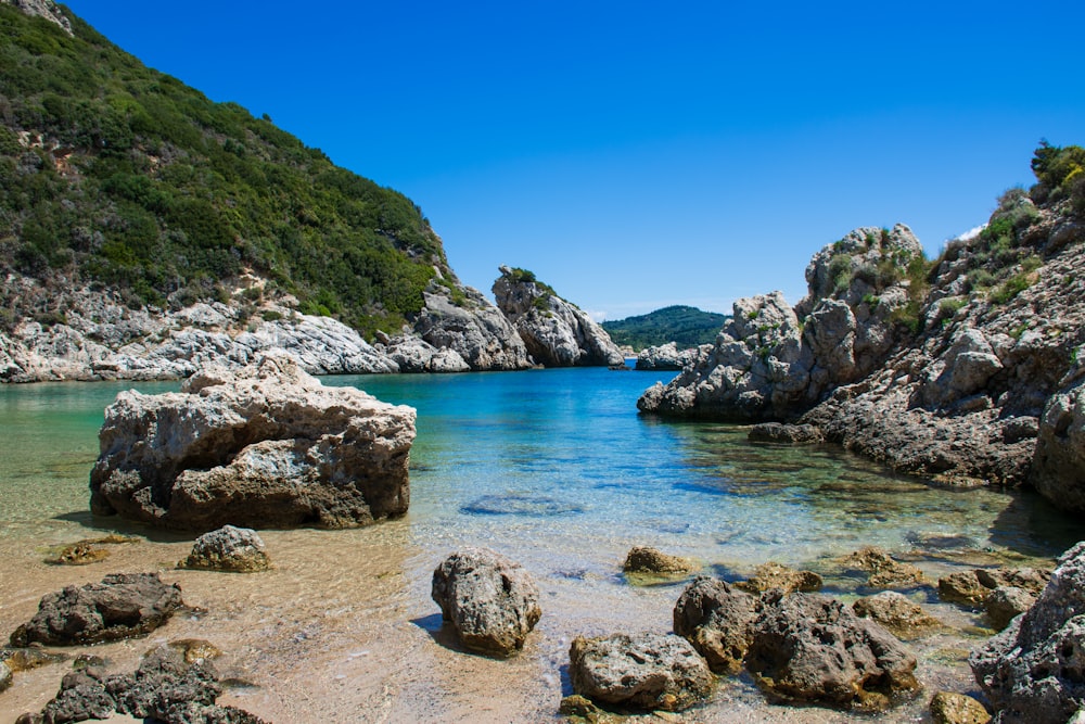 brown rock formation on blue sea under blue sky during daytime