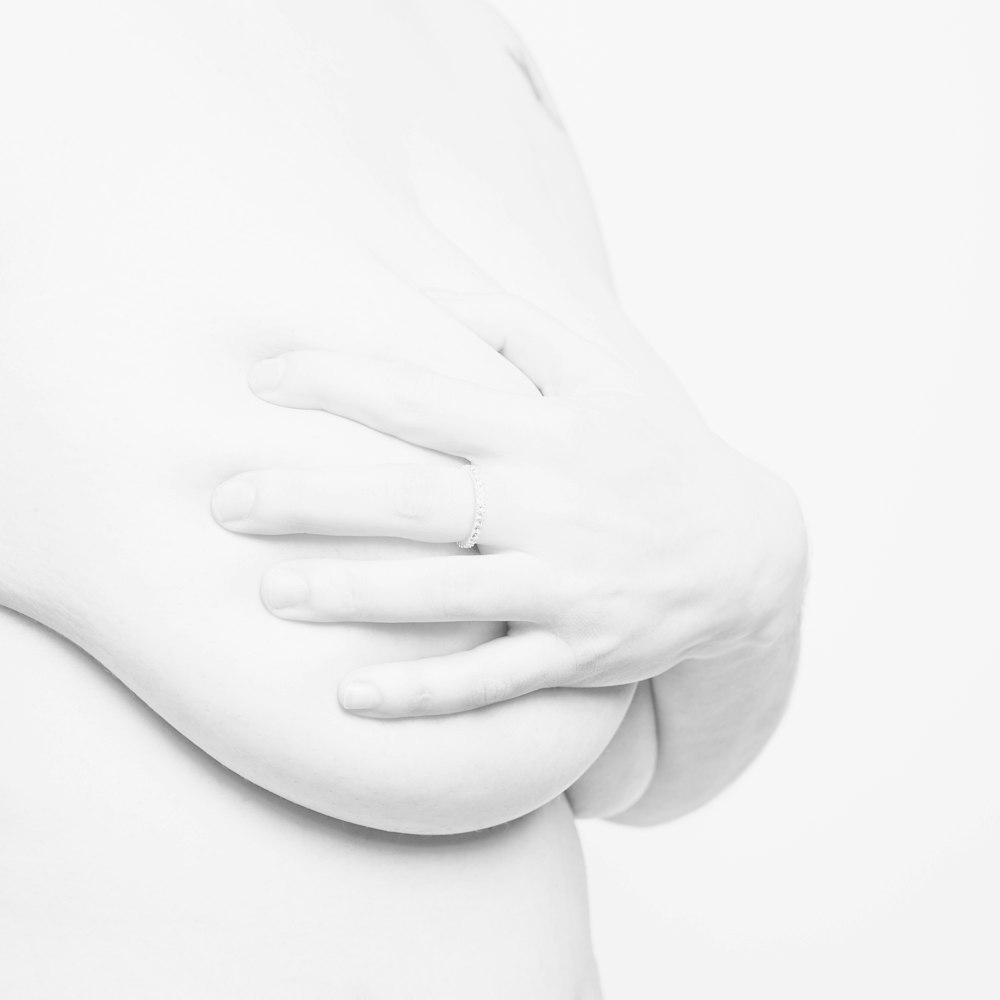 persons hand on white surface