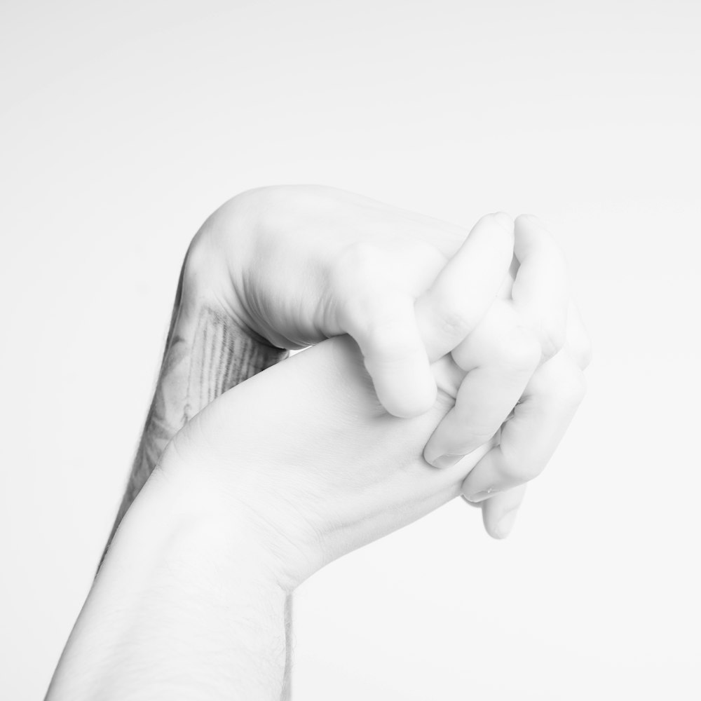 grayscale photo of persons hand