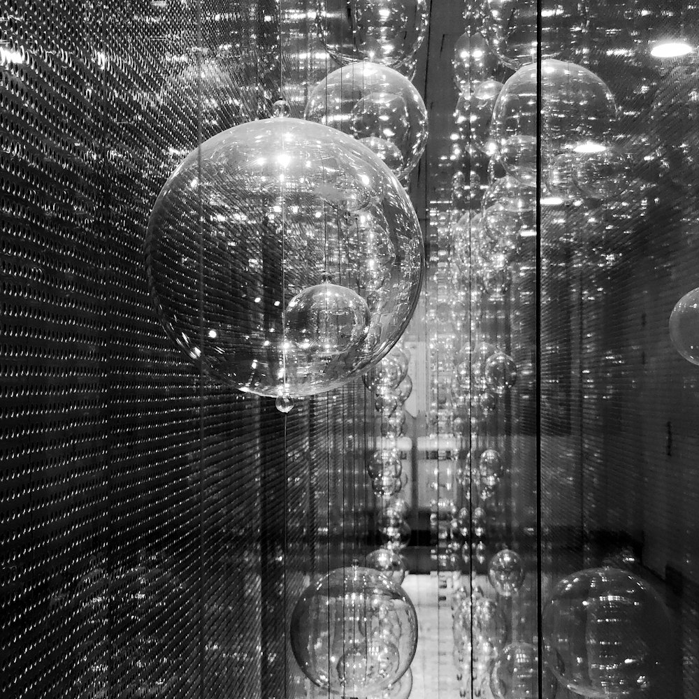 grayscale photo of bubbles on glass