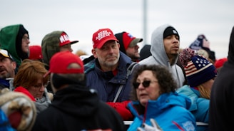 group of people in red cap and blue jacket