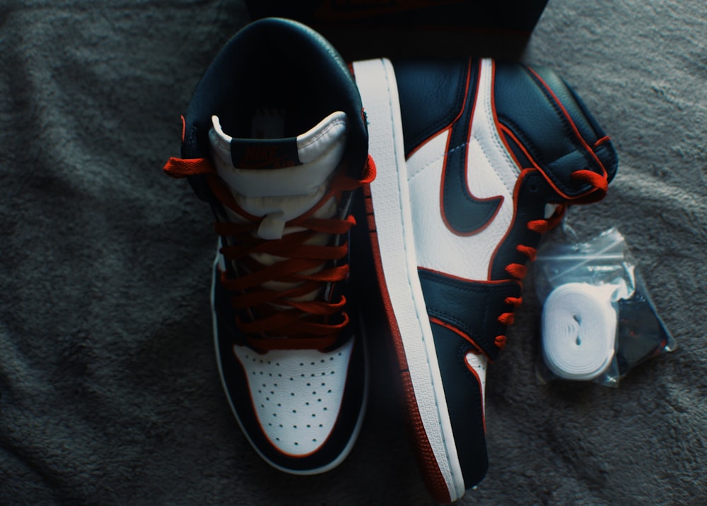 white black and orange nike athletic shoe