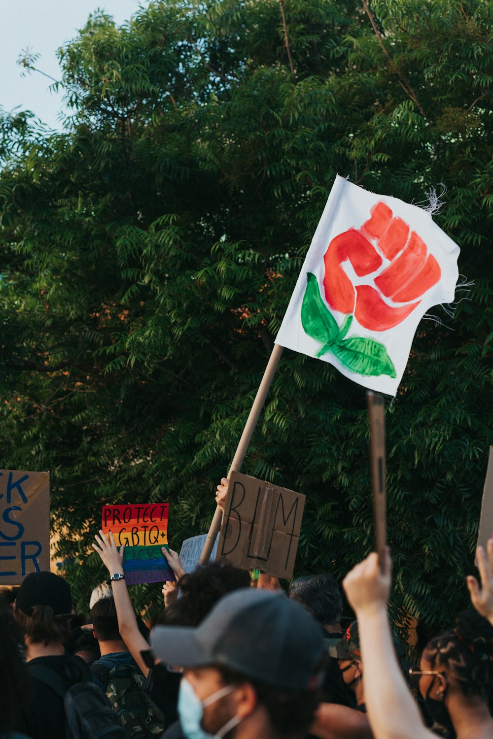 people holding red and white flag during daytime