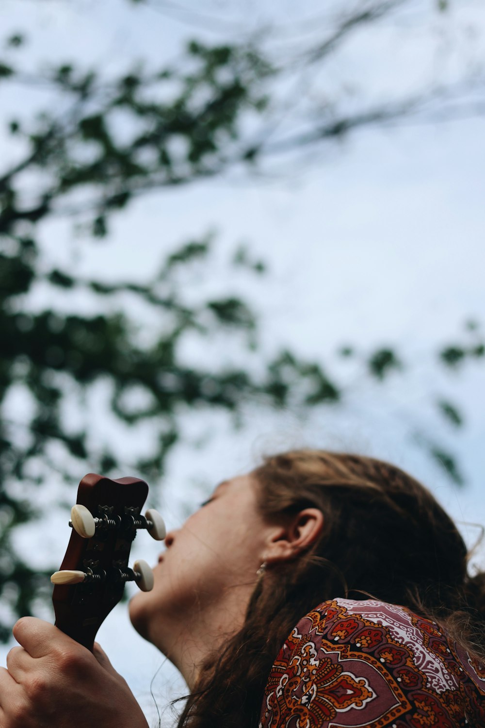 person holding red ceramic mug