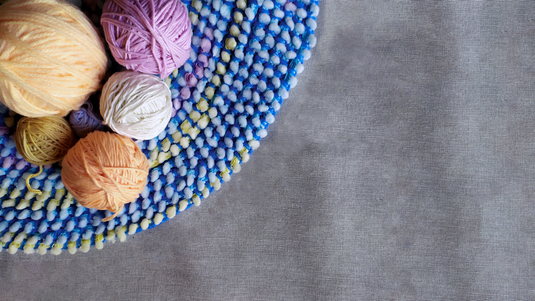 Basket of colourful yarn balls