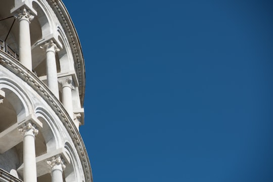 white concrete building under blue sky during daytime in Leaning Tower of Pisa Italy