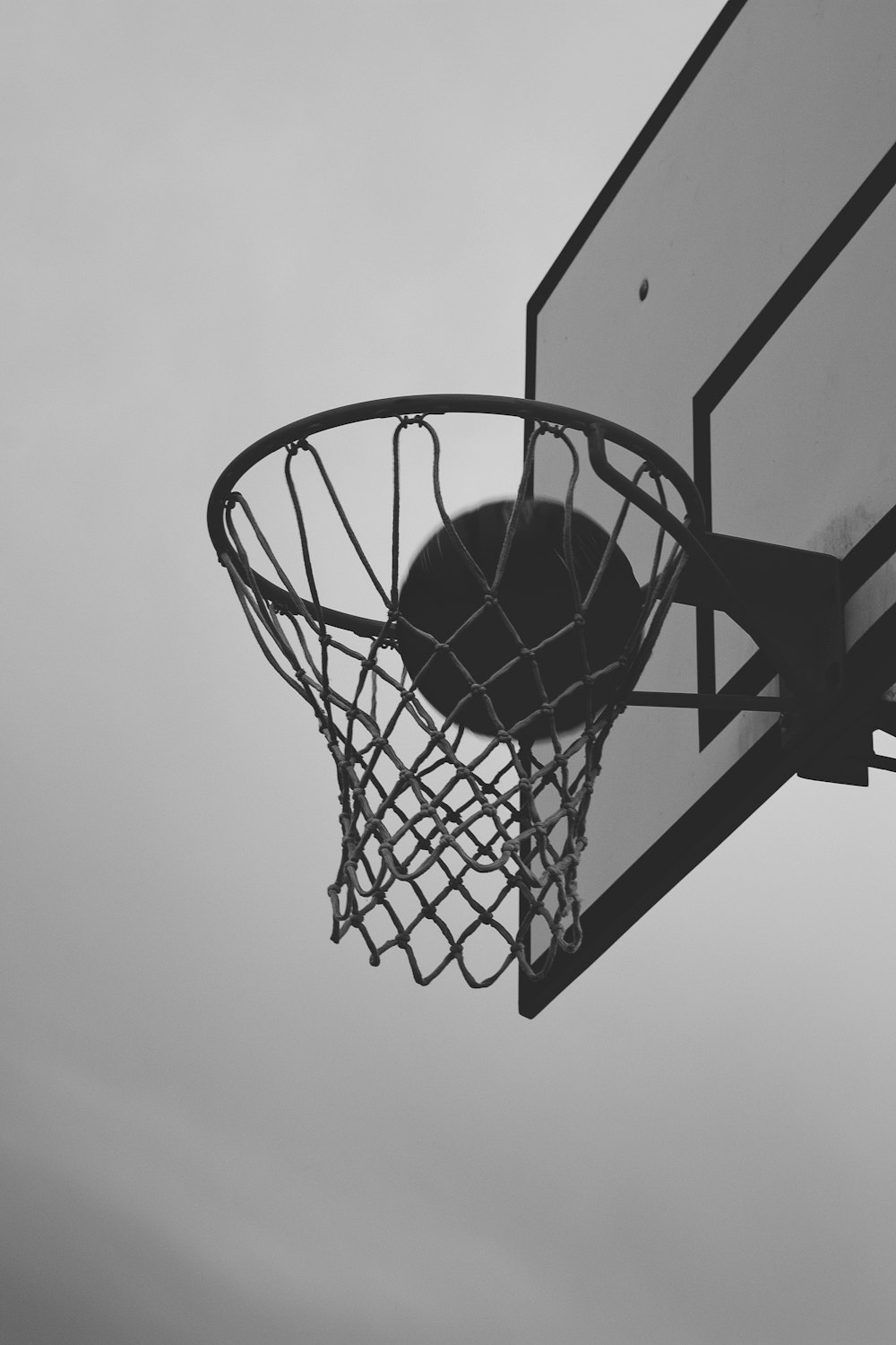 basketball hoop in grayscale photography